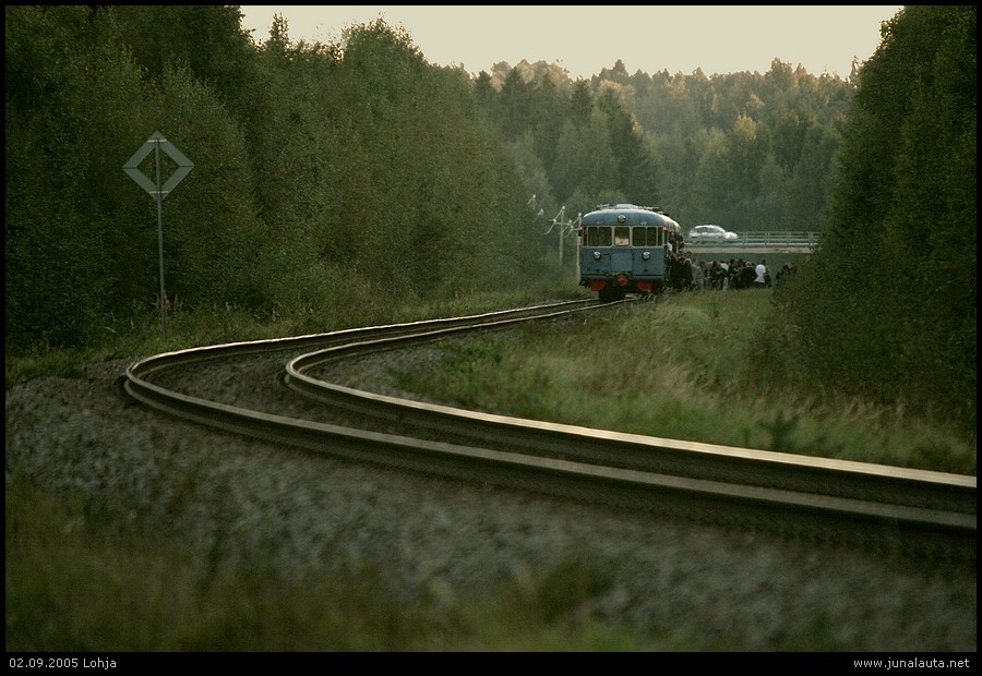 "Blues Train 2005" @ Gunnarla (Lohja) 02.09.2005
Kuva 1/4: 

Jo neljännen kerran järjestetty museojunakuljetus Lohjan Tanhuhoville on kuin uusinta viime vuodelta - kuvia myöten! Lähtöaika Ojakkalasta oli 18:25, Nummelasta 19:30 ja Lohjan asemalta 19:50. Tanhuhoviin saavuttiin aikataulun mukaisesti kello 20:00. Perinteistä tavarajunan ja lätän kohtausta ei tällä kertaa nähty Nummelassa eikä muillakaan asemilla, sillä T3679 kulki reilusti etuajassa. 

Tanhuhovin "seisake" sijaitsi tutulla paikalla, Kaivurinkadun ja taustalla pilkottavan vt25:n välissä, mistä oli muutaman sadan metrin kävelymatka metsäpolkua pitkin Tanhuhoville. Viime vuotinen lättäkokoonpano oli lihonnut muhkeasti neljän moottorivaunun (Dm7 4211+4163+4136+4207) ja yhden liitevaunun (Efiab 11639) pituiseksi, jotta kaikki halukkaat mahtuisivat kyytiin. 

Katso myös [url]http://www.grone.net/bluestrain[/url]

<<< Edellinen kuva | [url=http://www.junalauta.net/coppermine/thumbnails.php?album=search&search=BluesTrain2005]Kuvasarjan "Blues Train 2005" kaikki kuvat[/url] | [url=http://www.junalauta.net/coppermine/displayimage.php?pos=-697]Seuraava kuva >>>[/url]
Avainsanat: Dm7 Efiab museojuna lättähattu Dm7_4207 Dm7_4136 Dm7_4163 Dm7_4211 Efiab_11639 BluesTrain2005